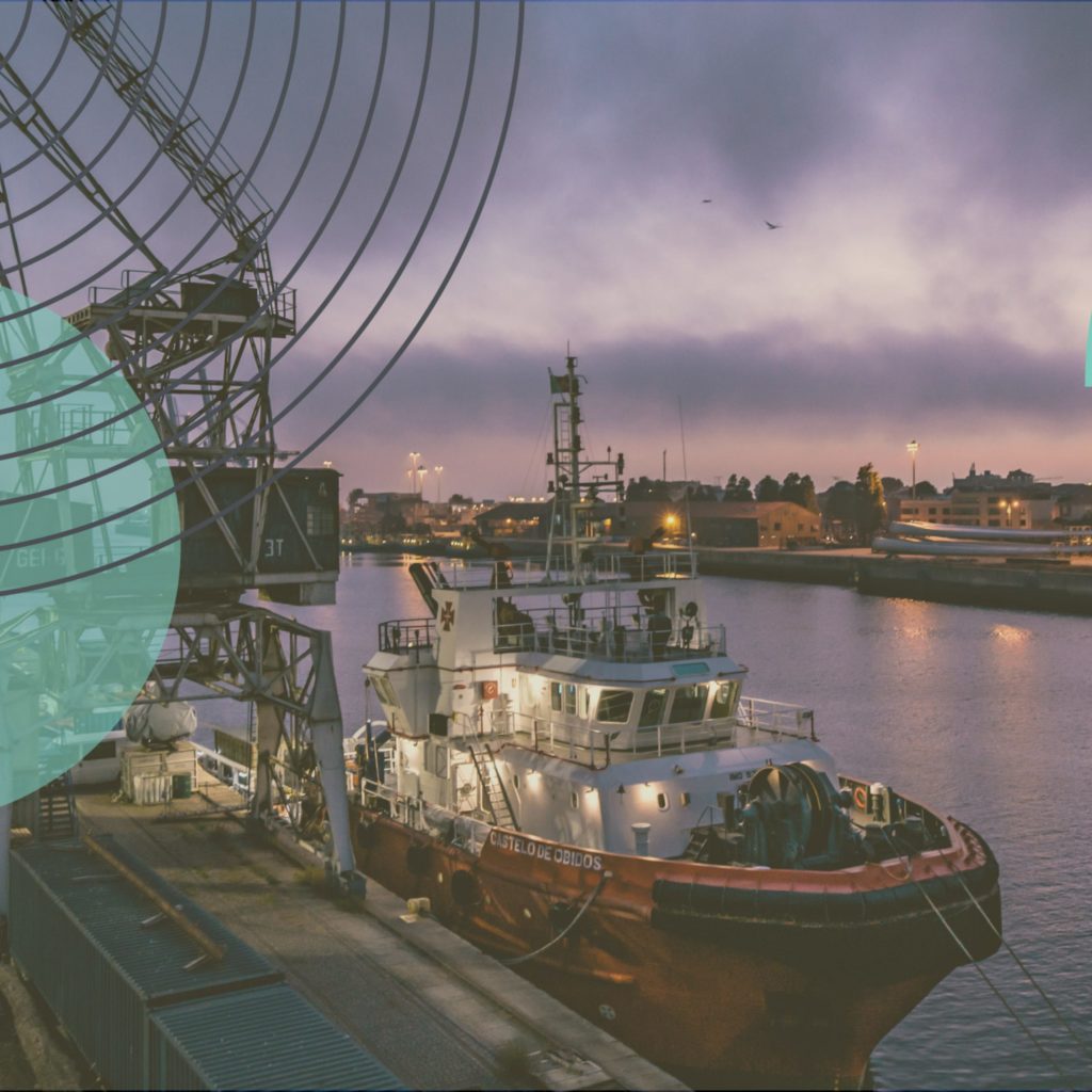 a cargo ship at a dock during night time with circle designs in the foreground.