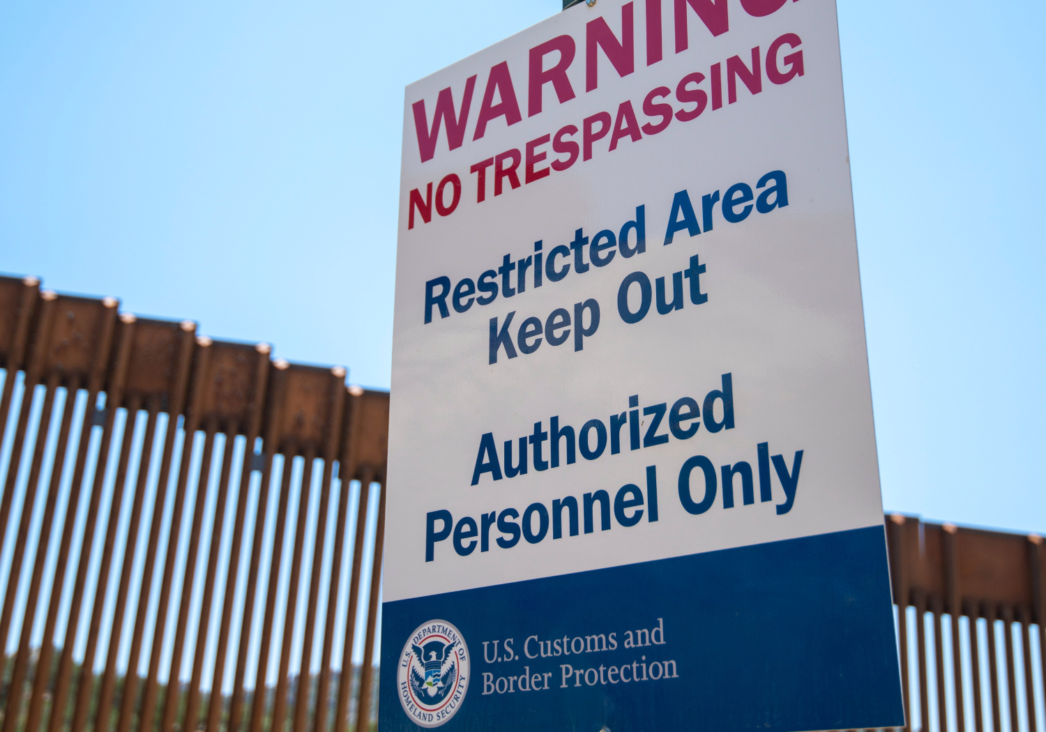 A sign that reads, "Warning No Trespassing. Restricted Area Keep Out. Authorized Personnel Only."