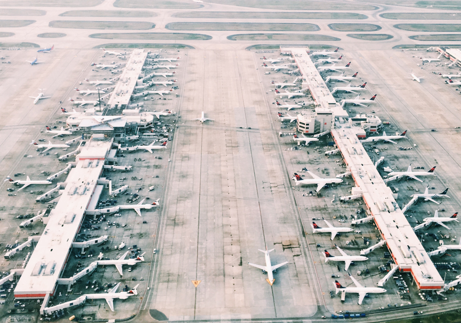 An aerial view of a busy airplane terminal.